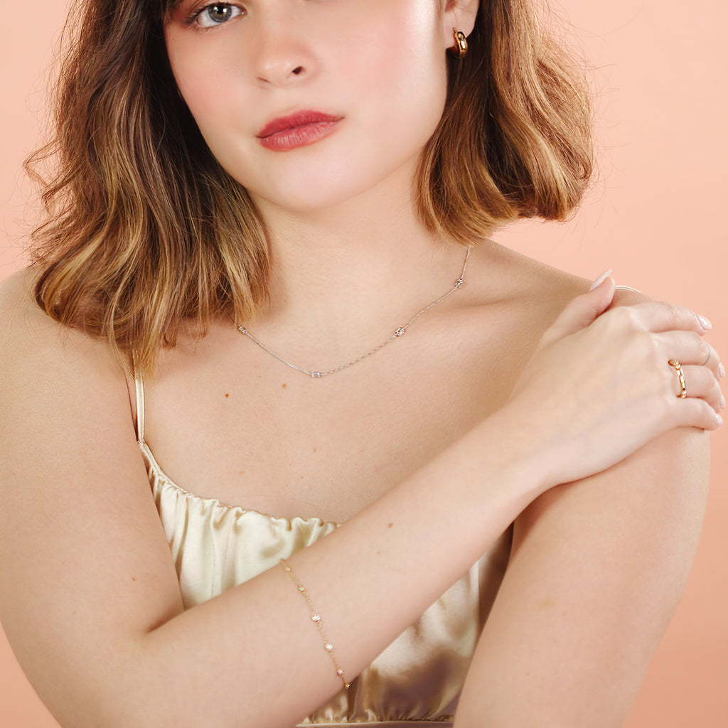 Floating Bracelet 14k gold stacked on model wrist – Foundry