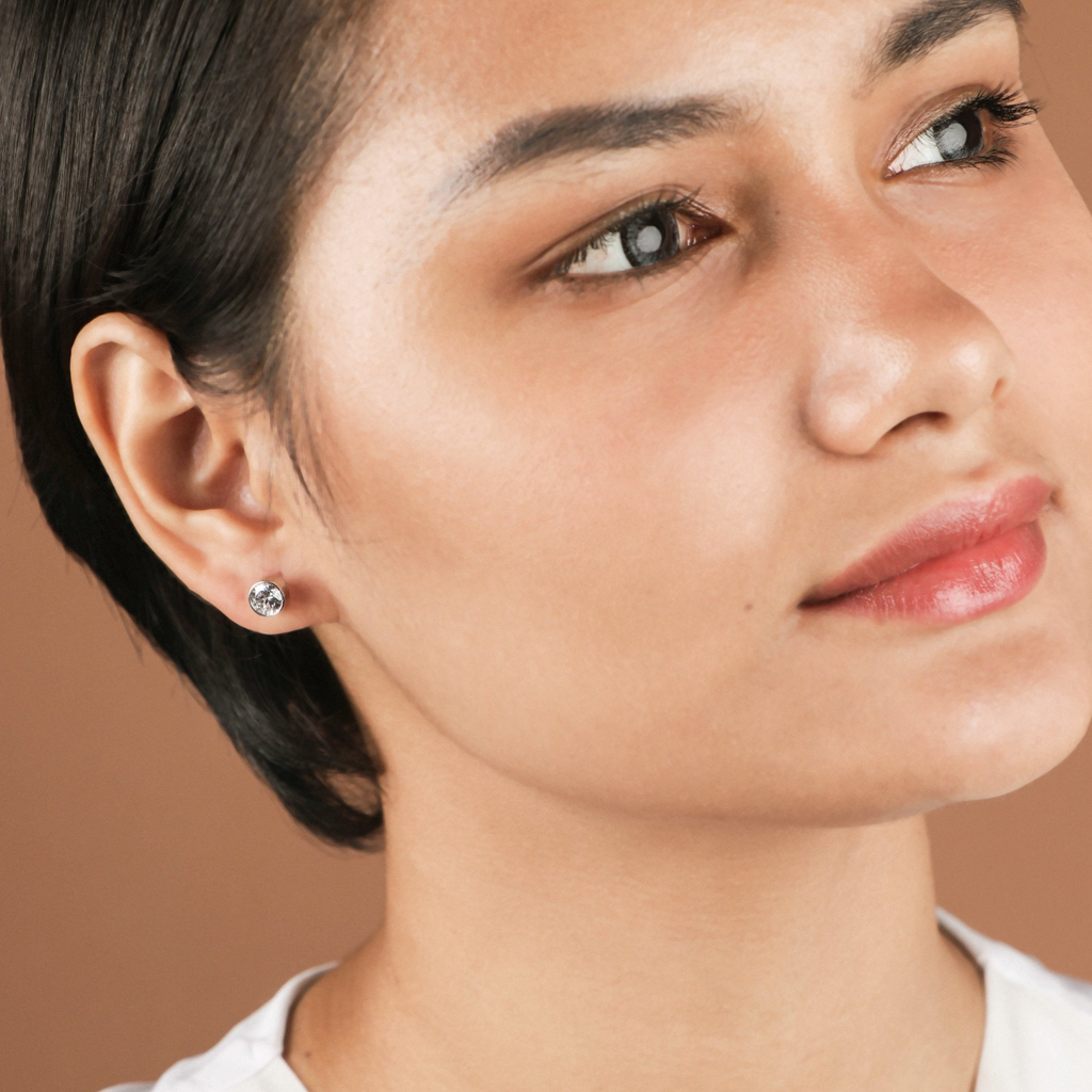 Solitaire Studs set in 18k solid gold. Cubic Zirconia set in bezel style. Arden Studs White Gold, Made in 18k solid gold