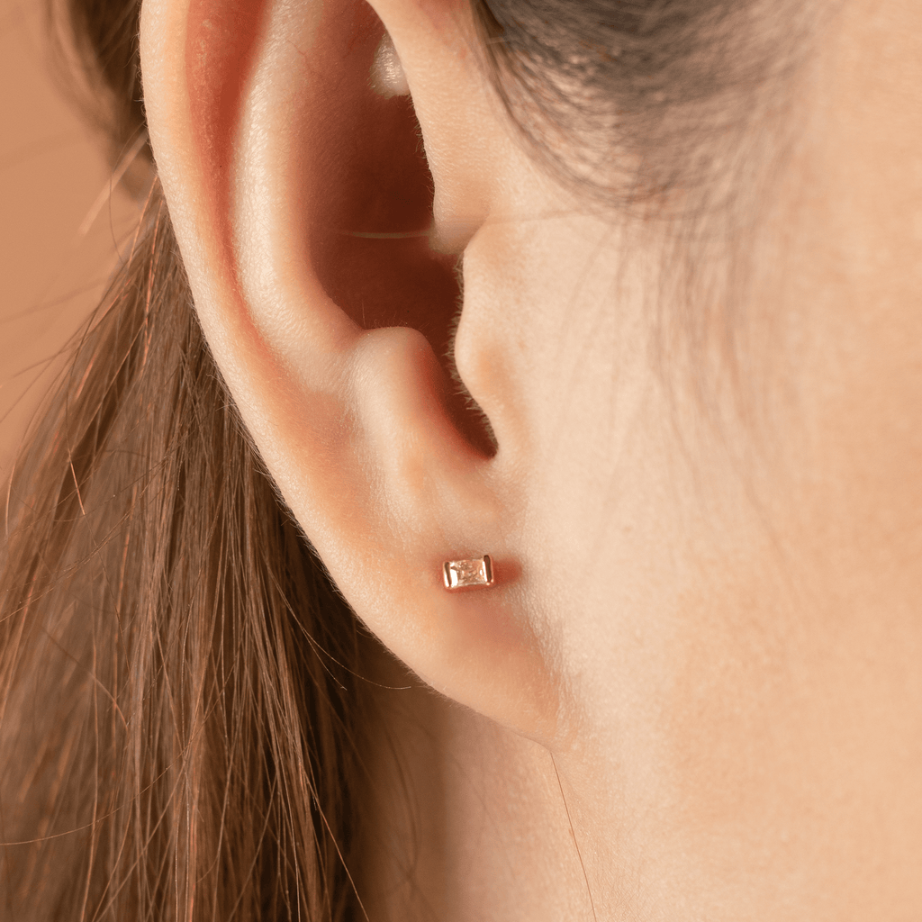 Baguette Diamond Studs 14k gold stacked with on model ears – Foundry