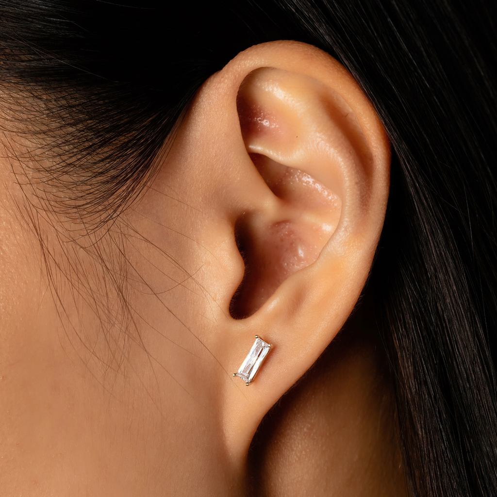 Baguette Studs 14k gold stacked on model ear – Foundry