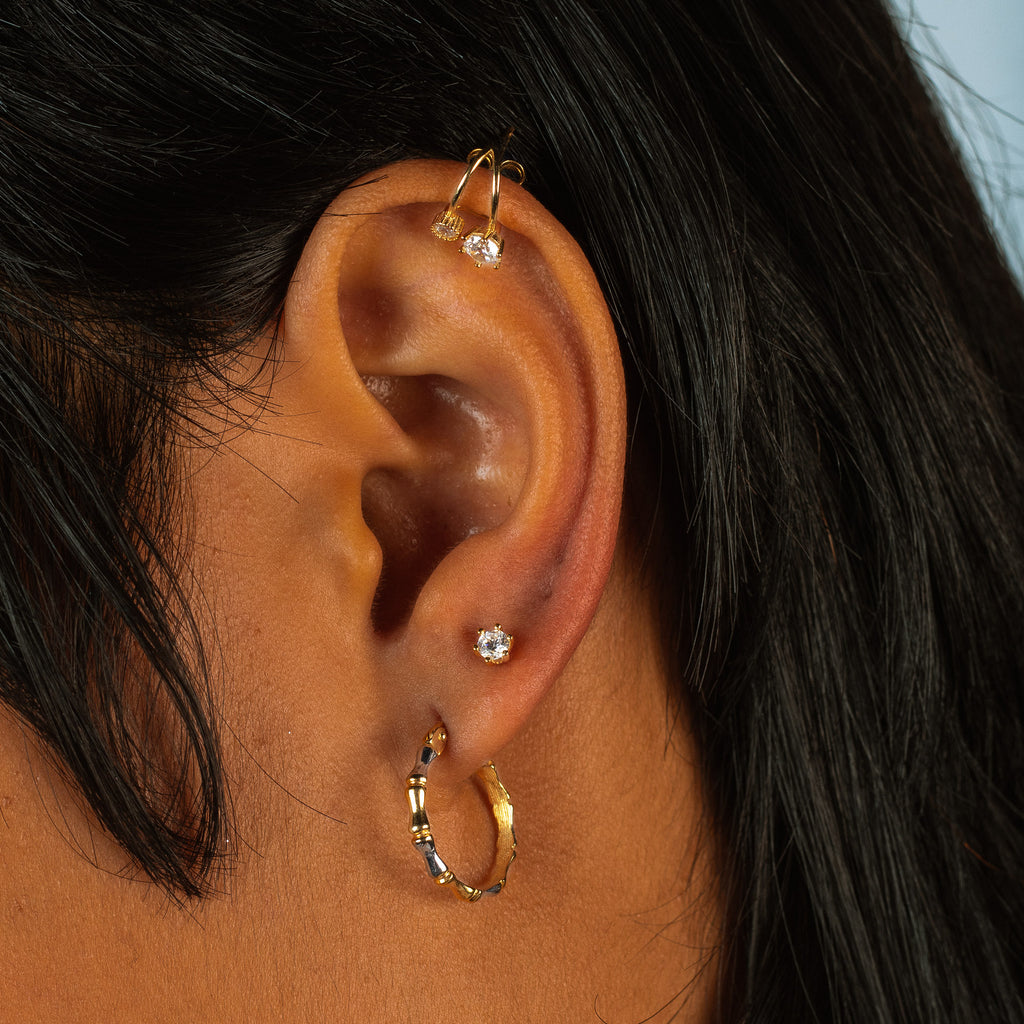 Bamboo Hoops 14k gold stacked on model ear– Foundry