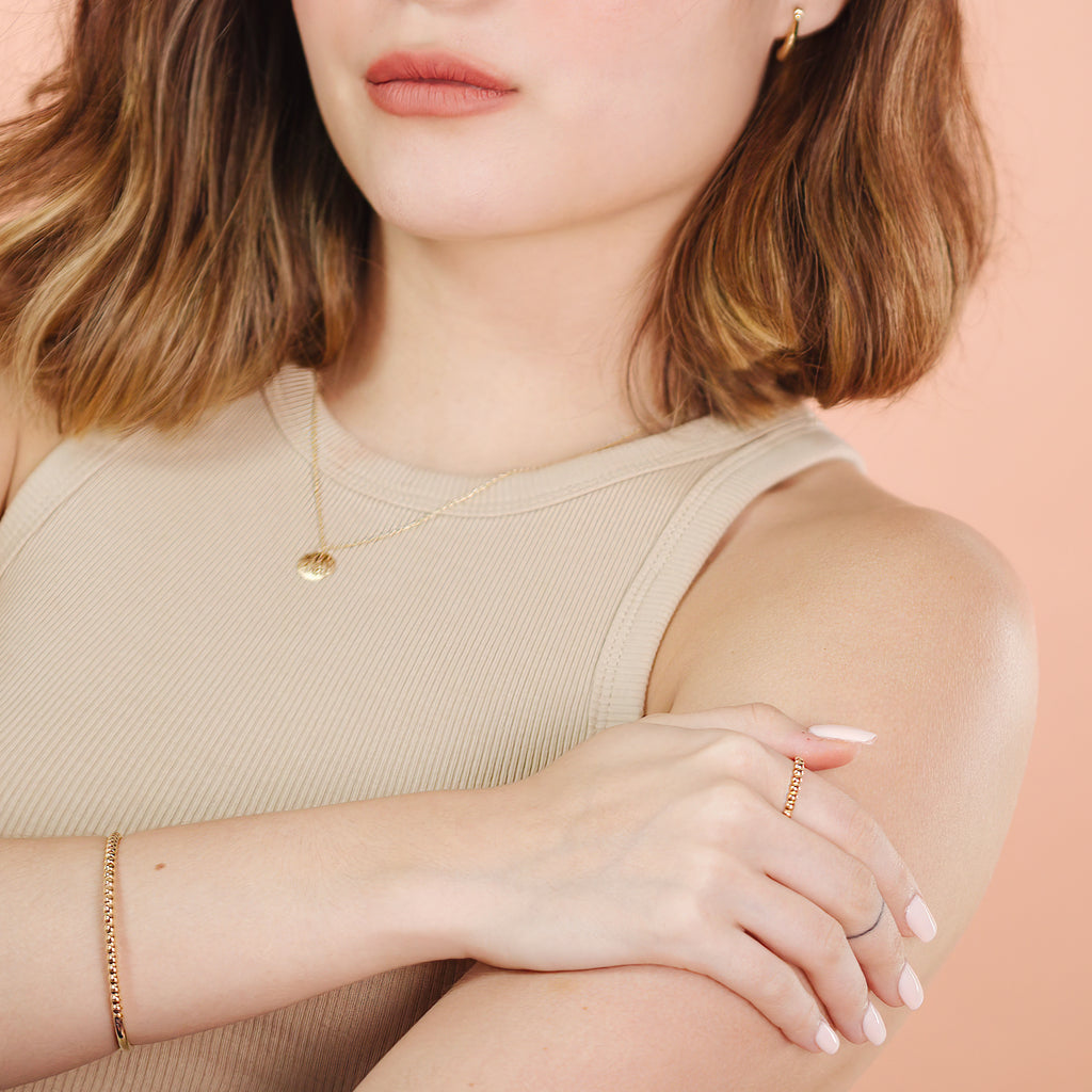 Beads Bold Bangle 14k gold stacked on model wrist – Foundry