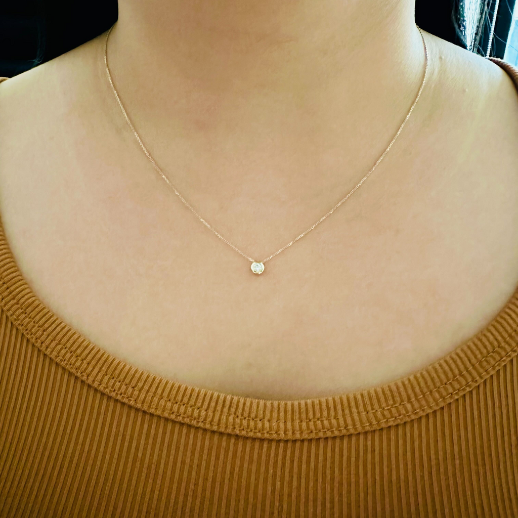 Bezel Cubic Zirconia Necklace 14k gold stacked on model neck – Foundry
