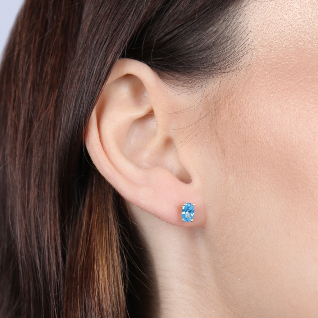 Birthstone Oval  Studs Aquamarine 18k gold stacked on model ear – Foundry