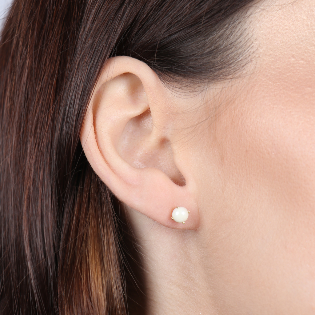 Birthstone Round Earrings June (Synthetic Pearl) 18k gold stacked on model ear – Foundry