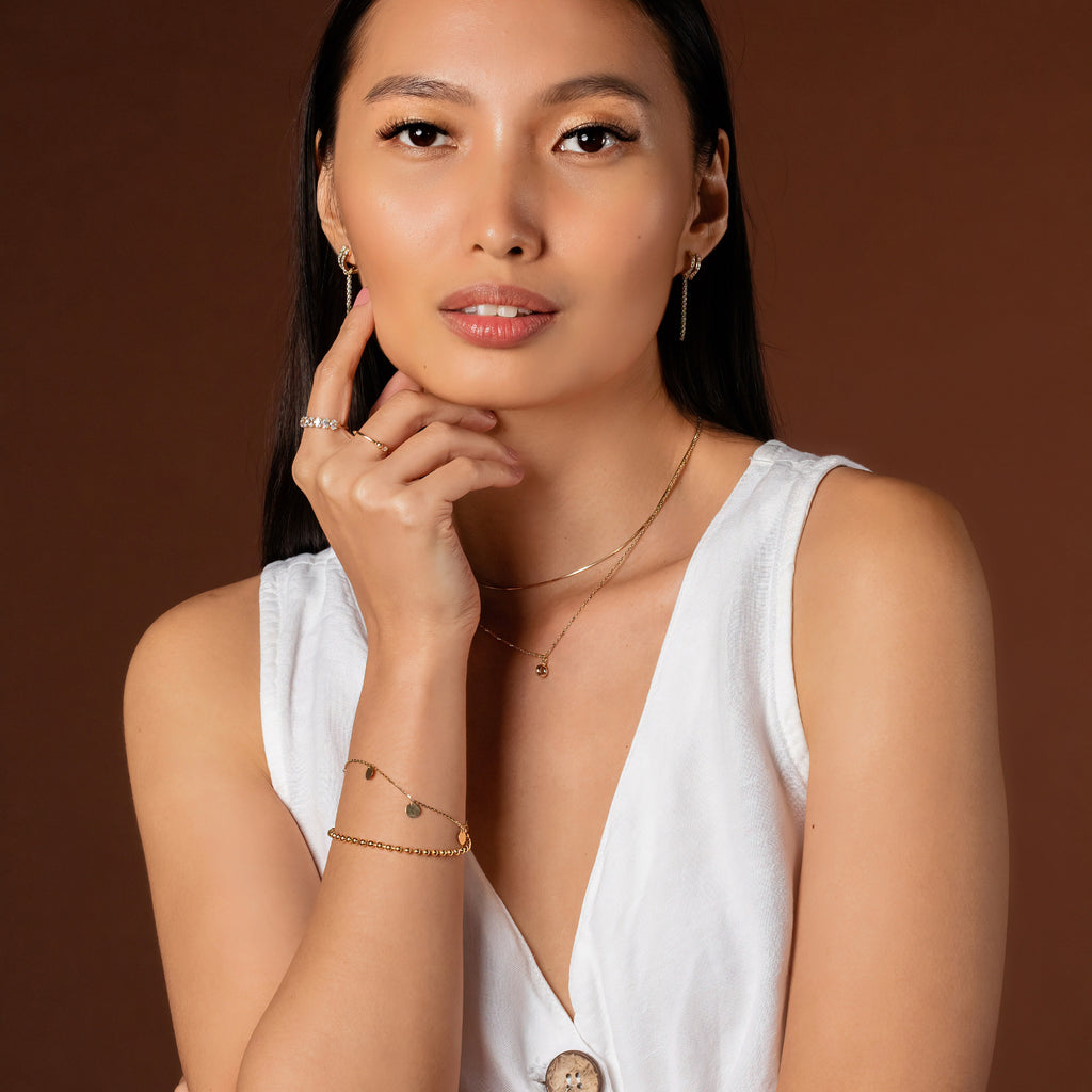 Birthstone Sphere Necklace Aquamarine 14k gold stacked on model neck – Foundry