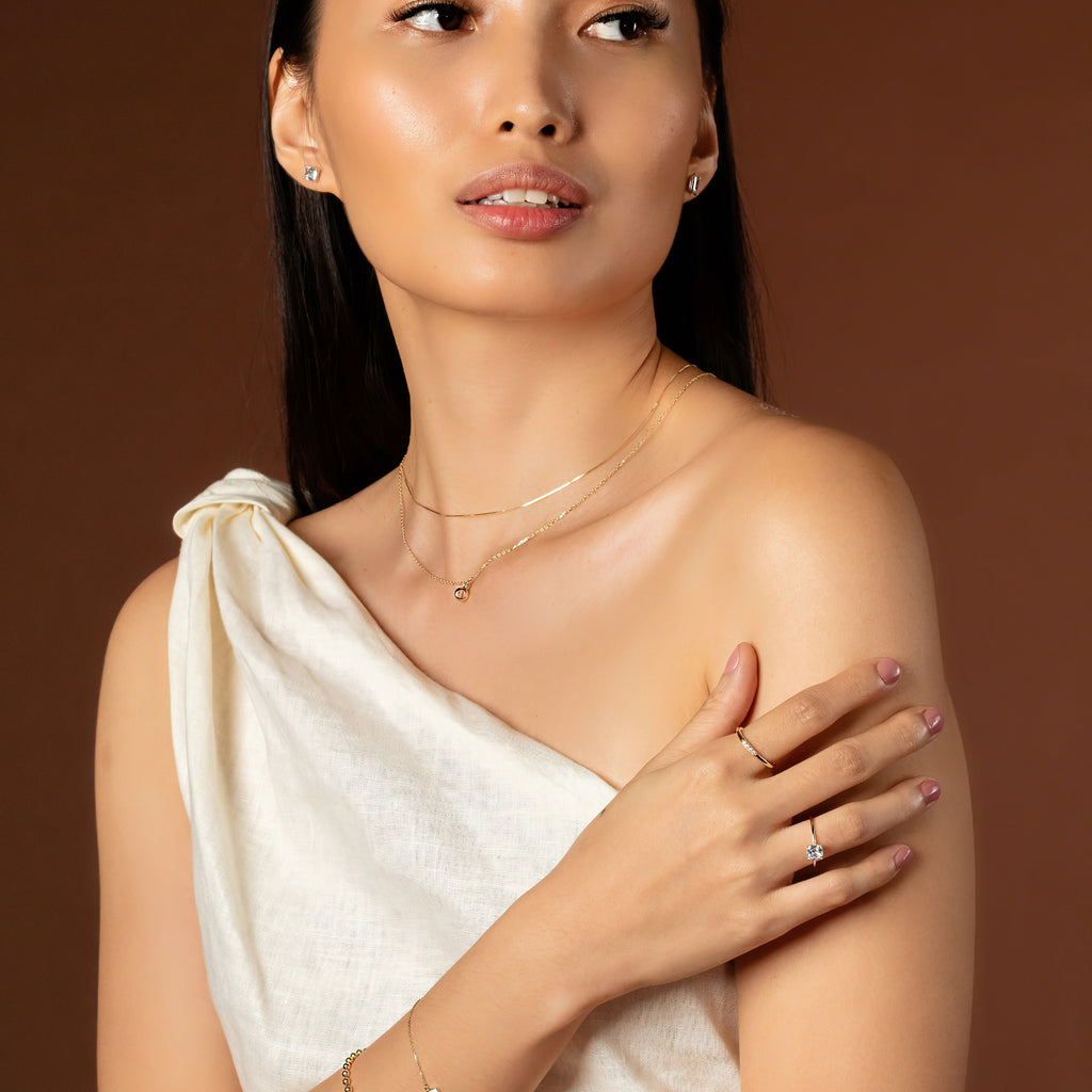 Birthstone Sphere Necklace White Quartz 14k gold stacked on model neck – Foundry