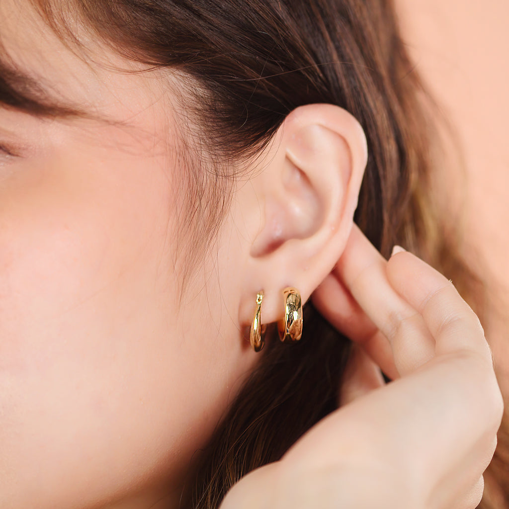 Boho Bold Hoops 14k gold stacked on model ear – Foundry