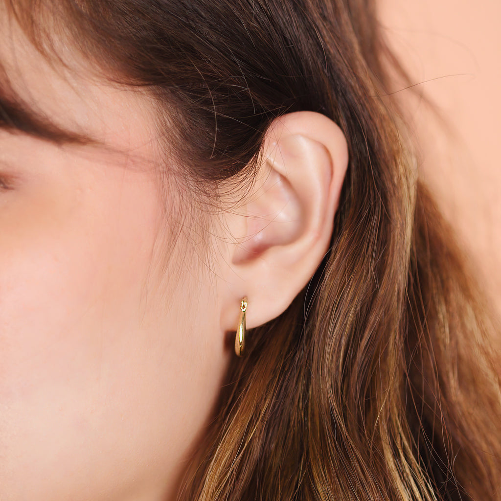 Boho Bold Hoops 14k gold stacked on model ear – Foundry