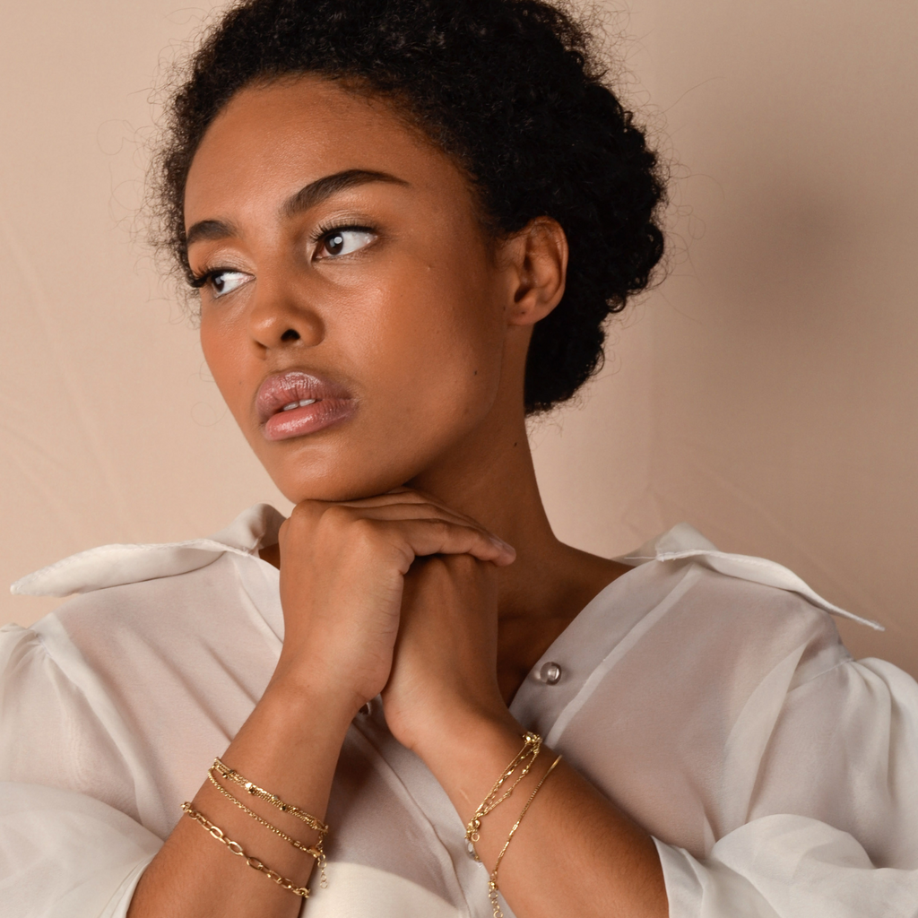 Bold Box Chain Bracelet 14k gold stacked on model wrist – Foundry