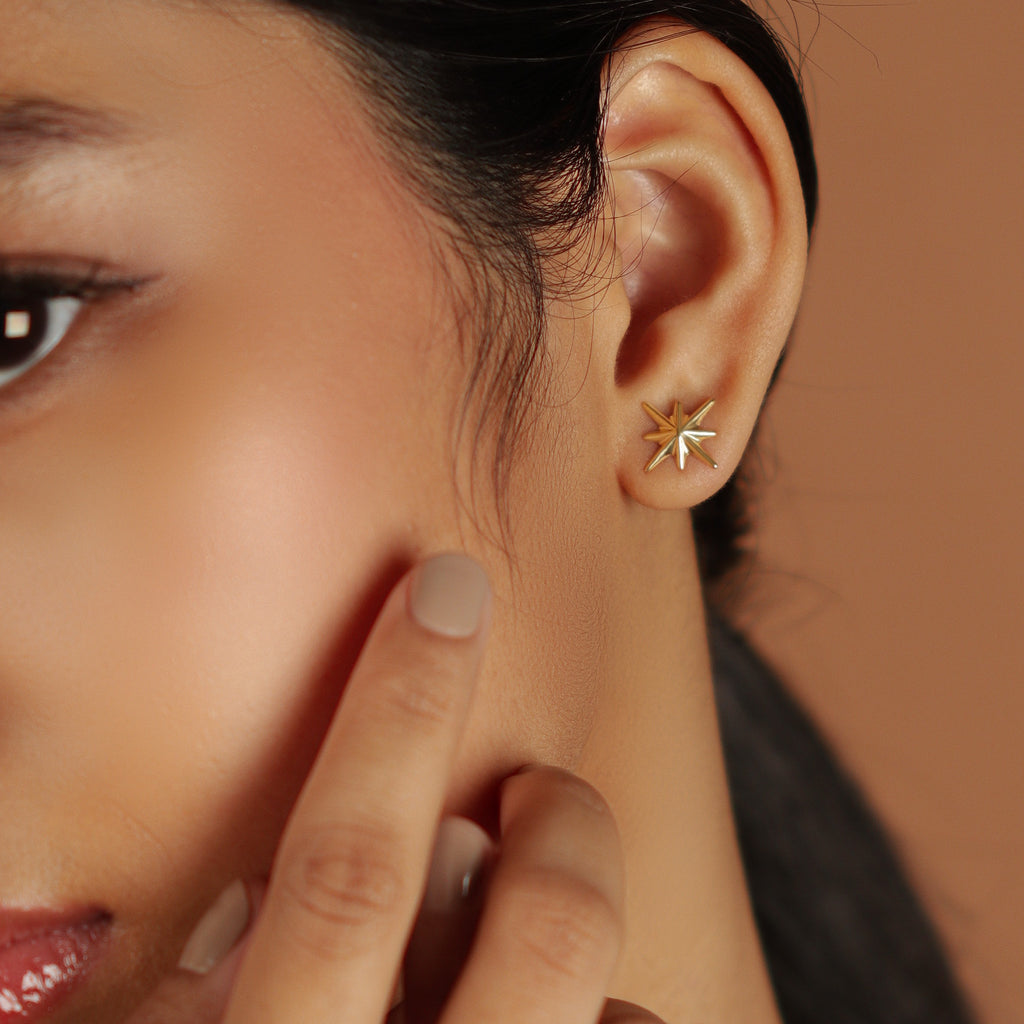 Bold Northstar Studs 18k gold stacked on model ears – Foundry