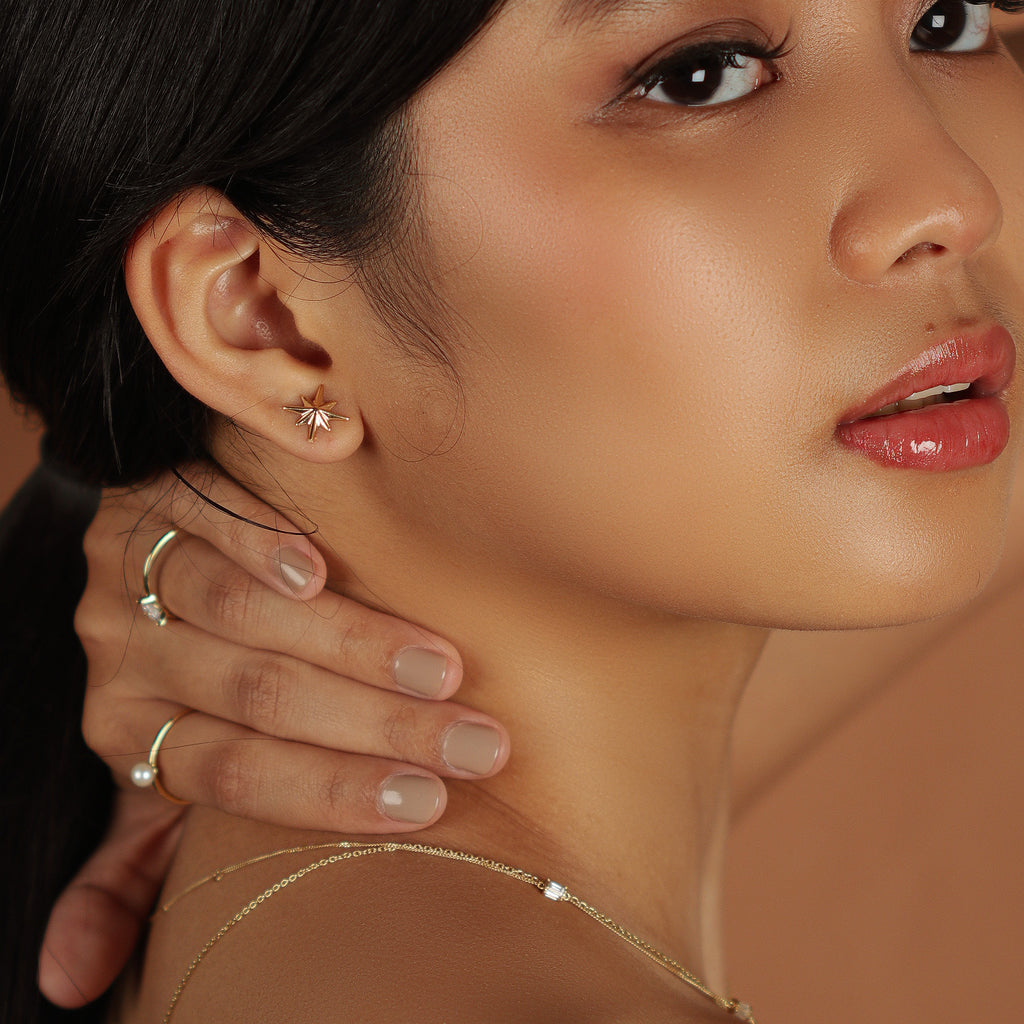 Bold Northstar Studs 18k gold stacked on model ear – Foundry