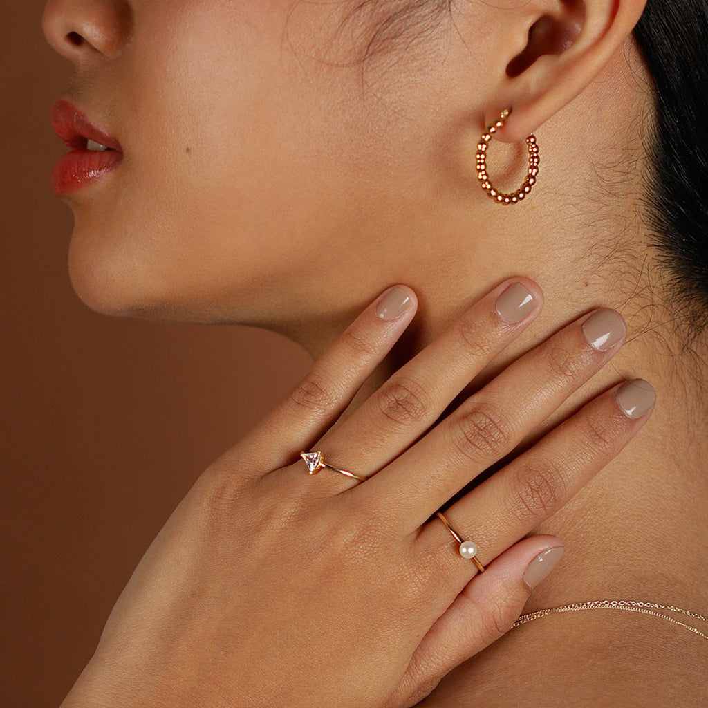 Bold Sphere Hoops 14k gold stacked on model ear – Foundry