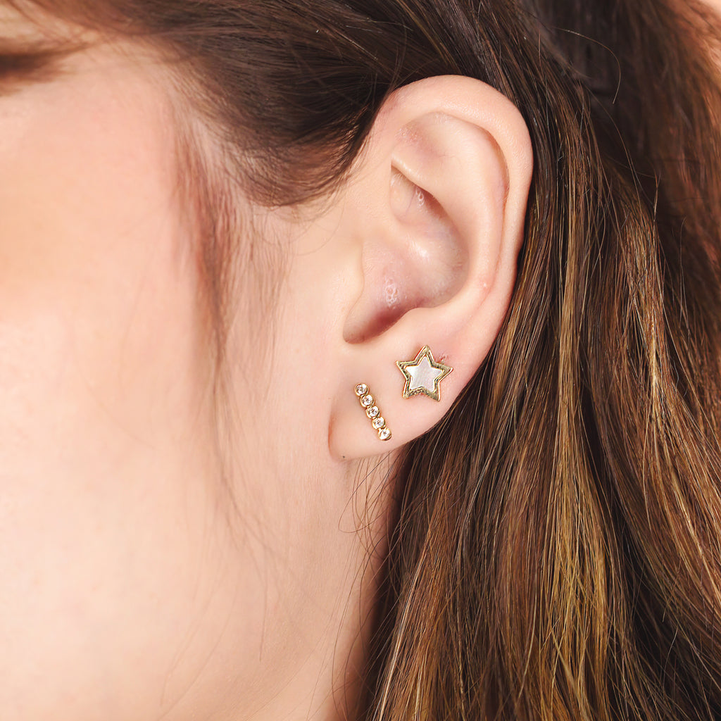 Brilliant Bar Stud 14k gold stacked on model ear – Foundry