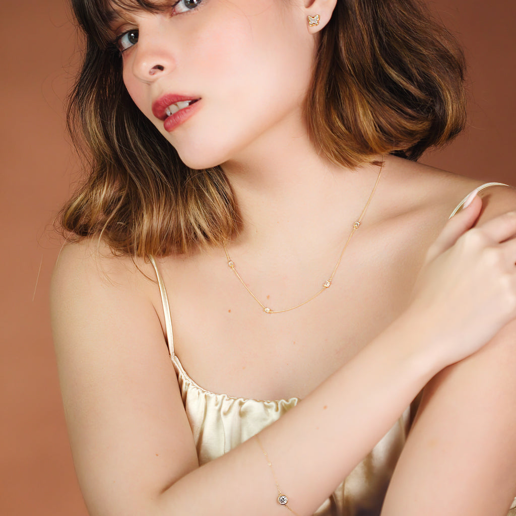 Butterfly Mother of Pearl Studs 14k gold stacked on model ear – Foundry