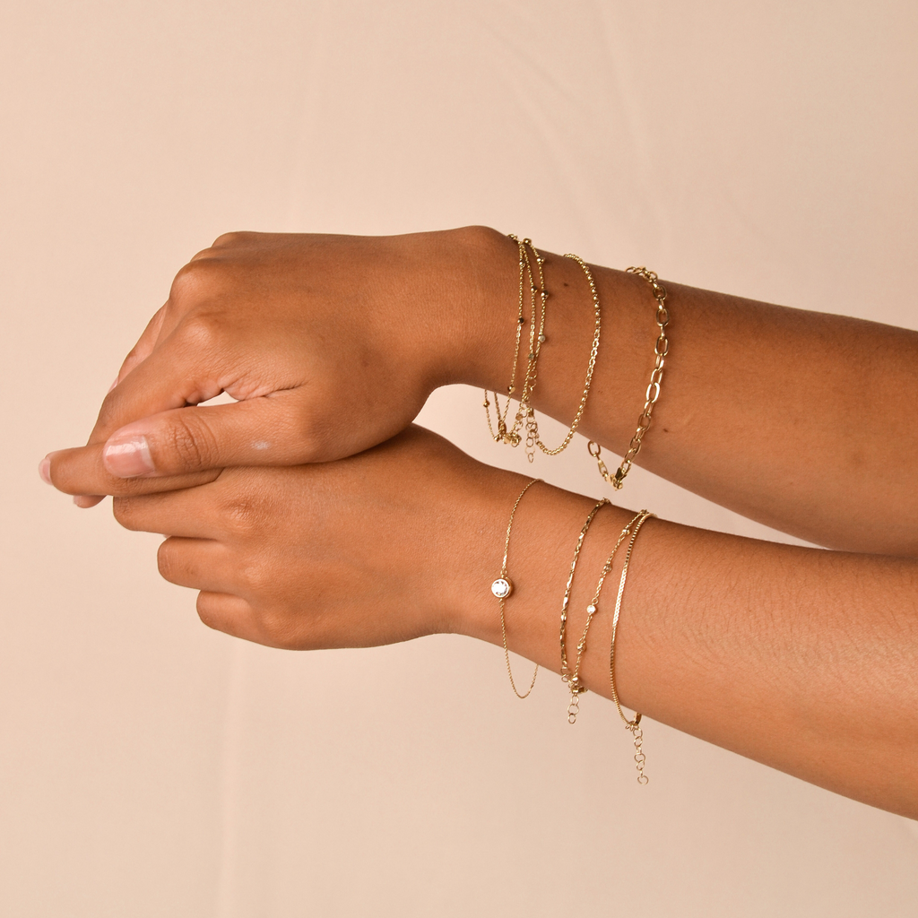 Cable Chain Bracelet 14k gold stacked on model wrist – Foundry