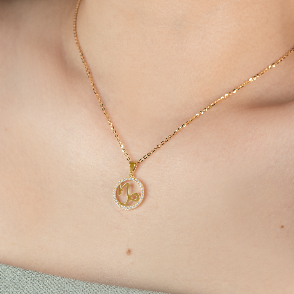 Capricorn Pendant 14k gold stacked on model neck– Foundry