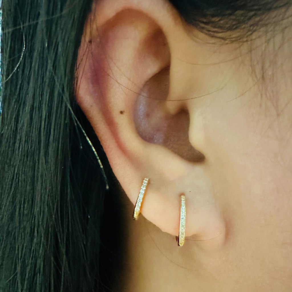 Channel Diamond Huggie Hoops 18k gold stacked on model ear – Foundry