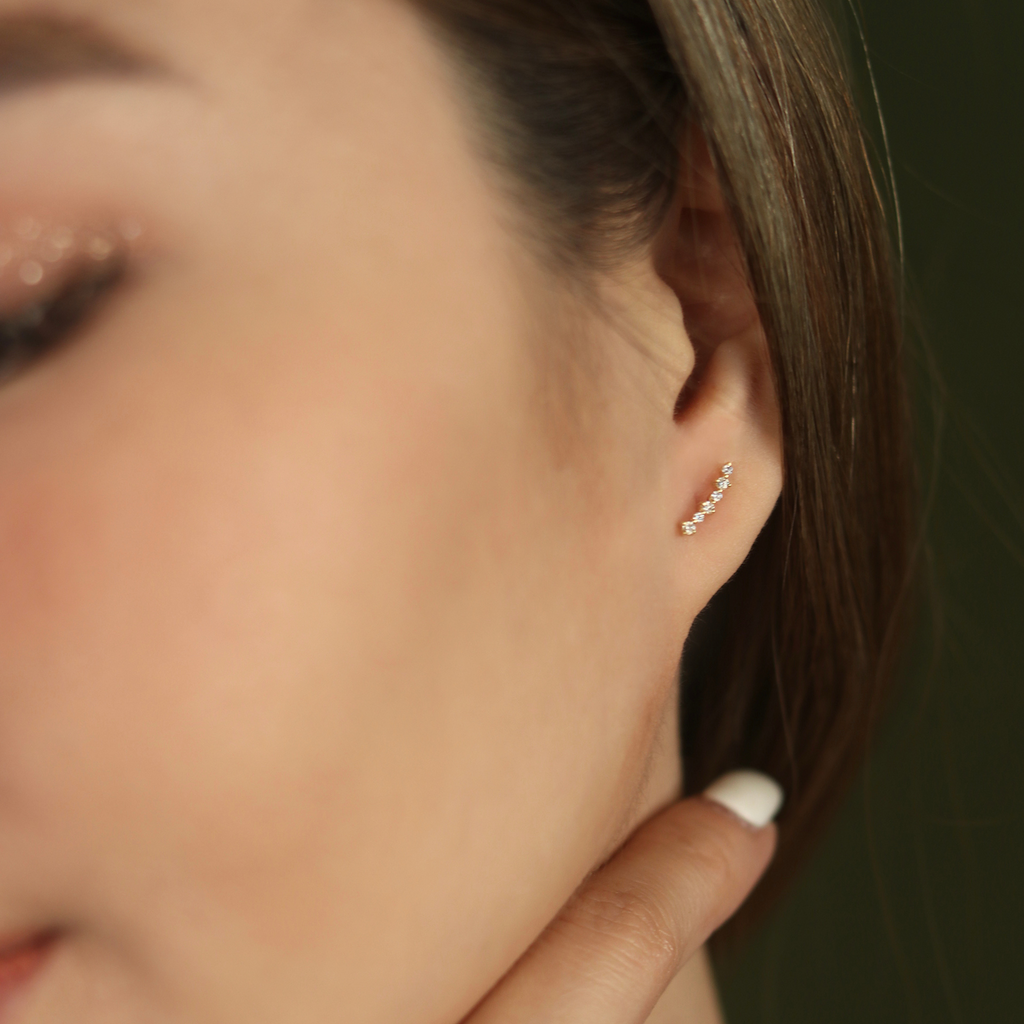 Diamond Cluster Climber Studs 14k gold stacked on model ear – Foundry