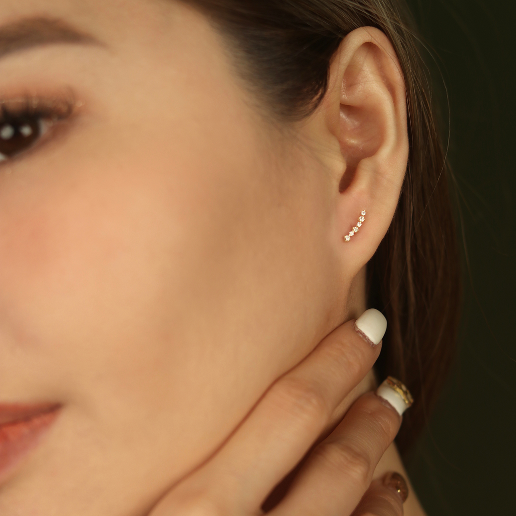 Diamond Cluster Climber Studs 14k gold stacked on model ear – Foundry