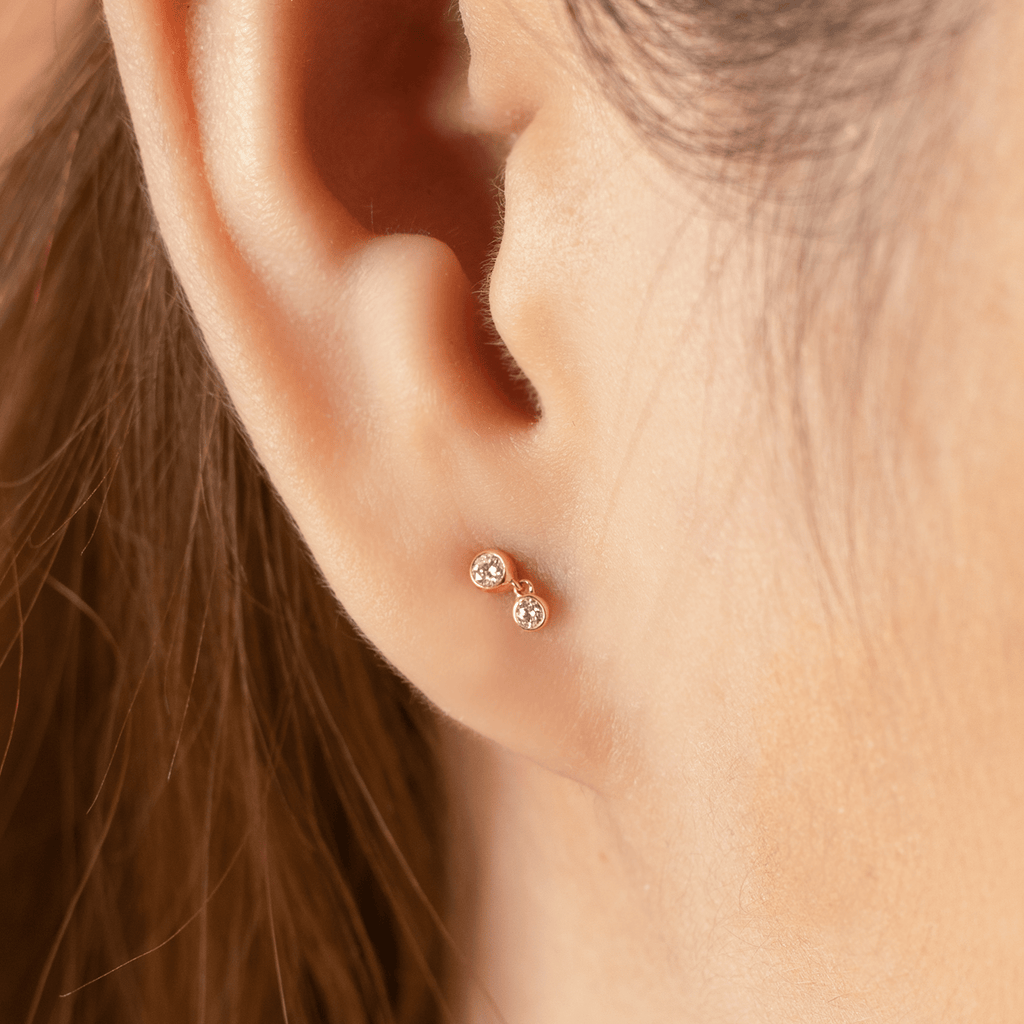 Diamond Station Studs 14k gold stacked on model ears – Foundry