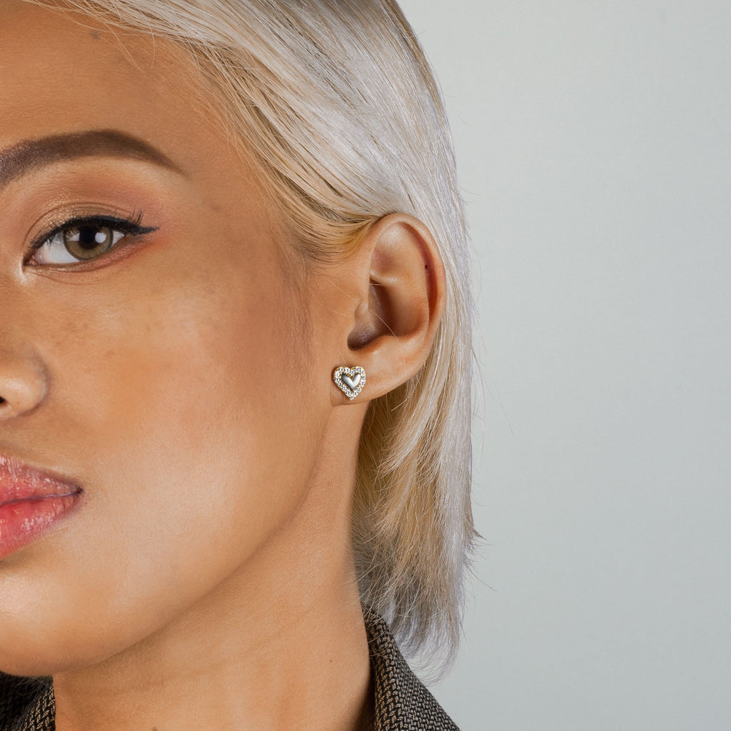 Elevated Heart Studs 14k gold stacked on model ears – Foundry