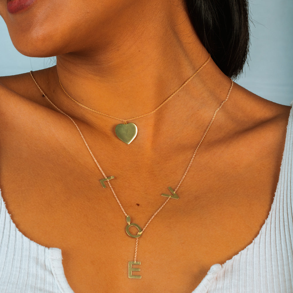 Engravable Heart Necklace 18k gold stacked on model neck – Foundry