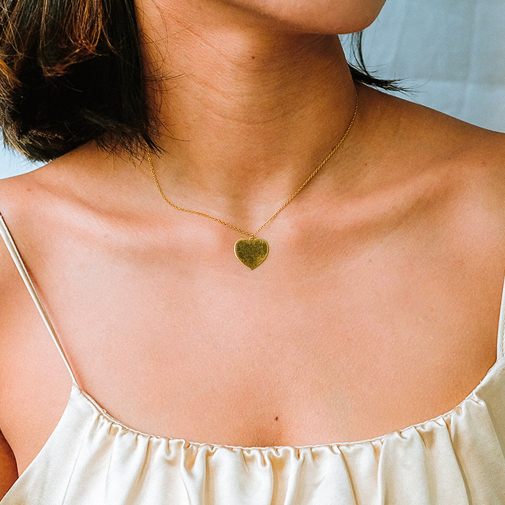 Engravable Heart Necklace 18k gold stacked on model neck – Foundry
