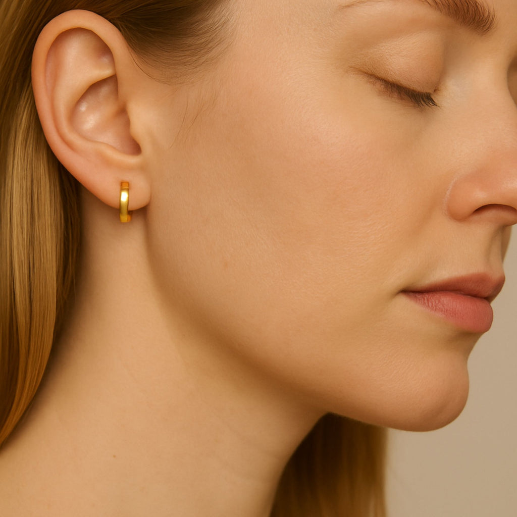 Essential Hoop Earrings 18k gold stacked on model ears – Foundry