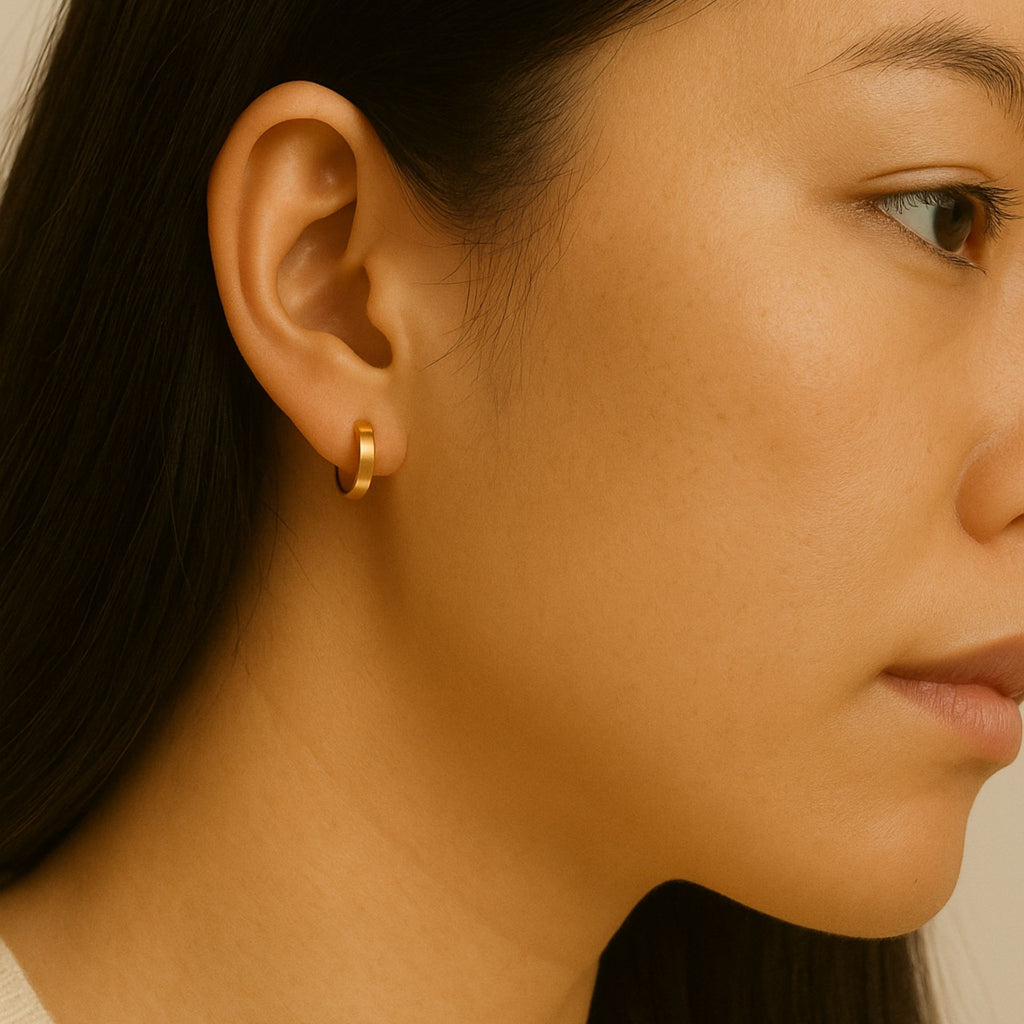 Essential Hoop Earrings 18k gold stacked on model ears
