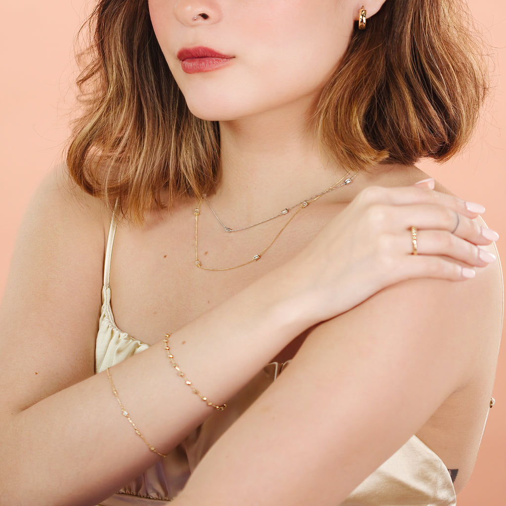 Floating Bracelet 14k gold stacked on model wrist – Foundry