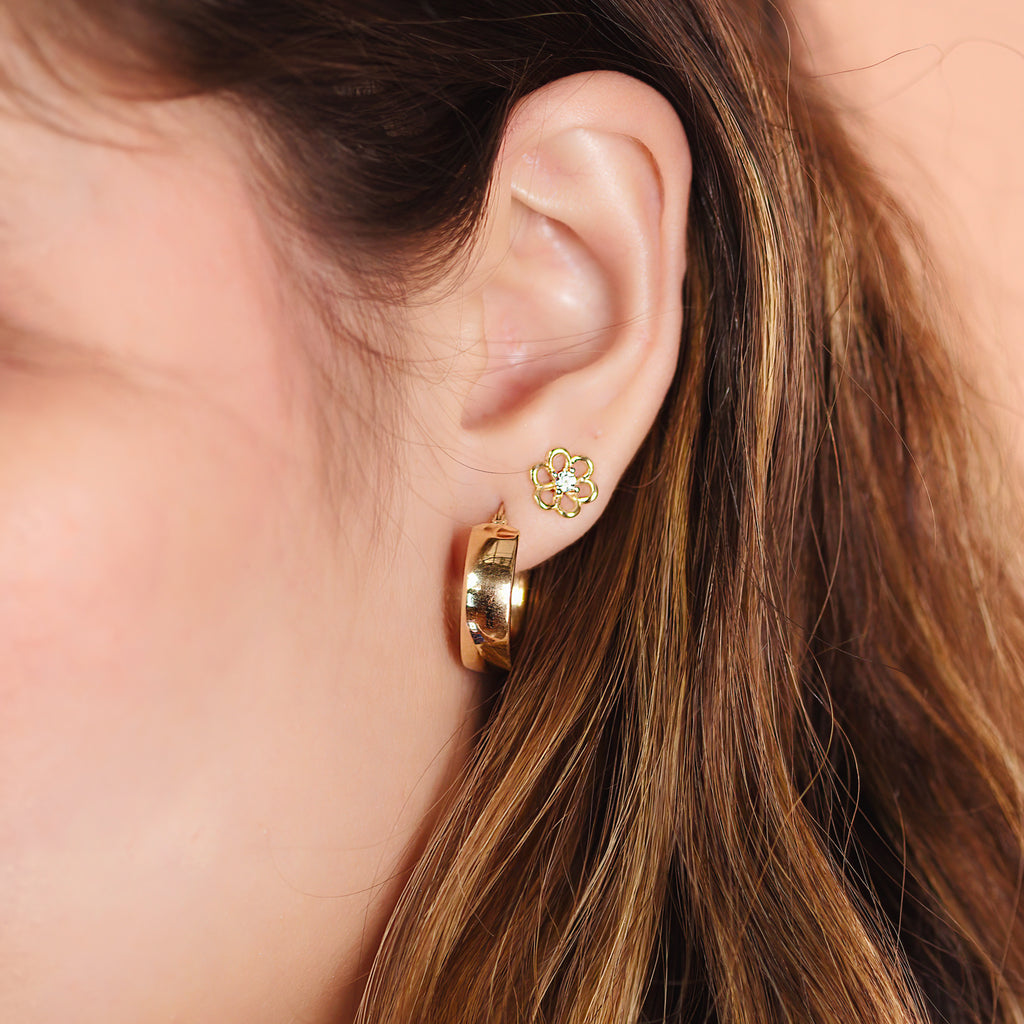Flower Solo Studs 14k gold stacked on model ear  – Foundry