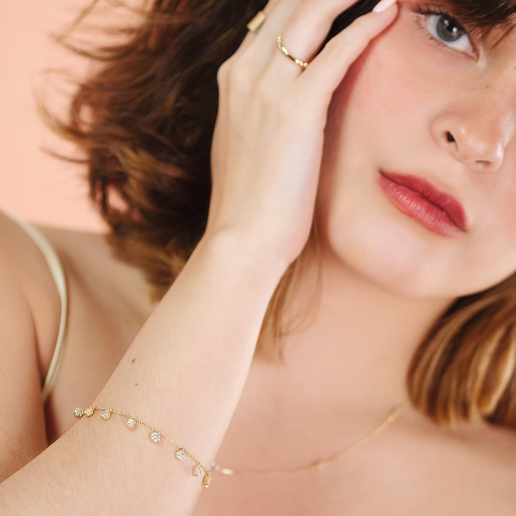 Flower Station Bracelet 14k gold stacked on model wrist – Foundry
