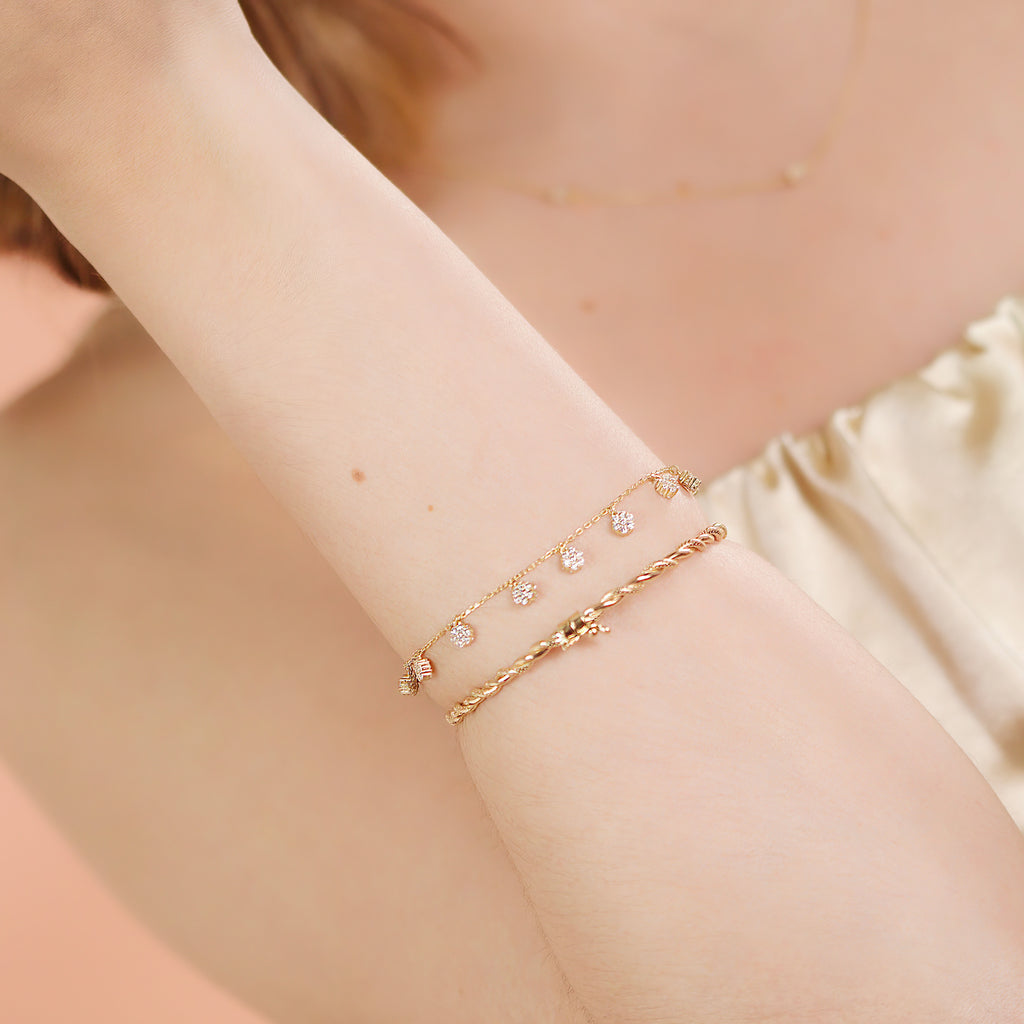 Flower Station Bracelet 14k gold stacked on model wrist – Foundry
