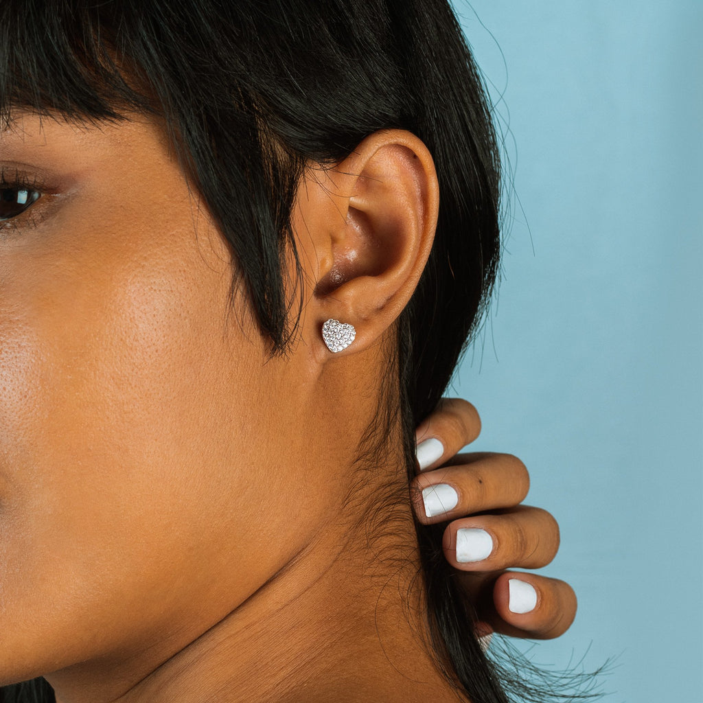 Heart Glow Studs 18k gold stacked on model ear – Foundry