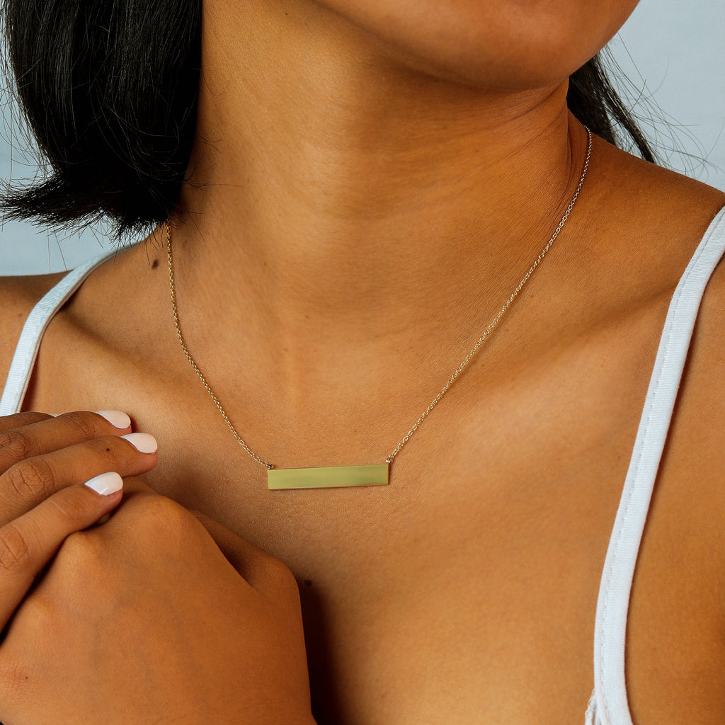 Horizon Engravable Bar Necklace 14k gold stacked on model neck – Foundry