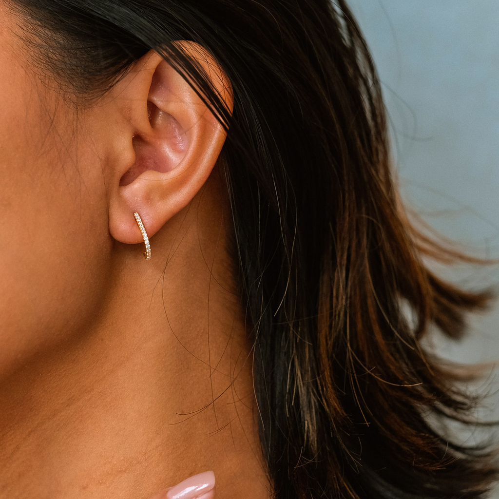 J Hook Studs 18k gold stacked on model ear – Foundry