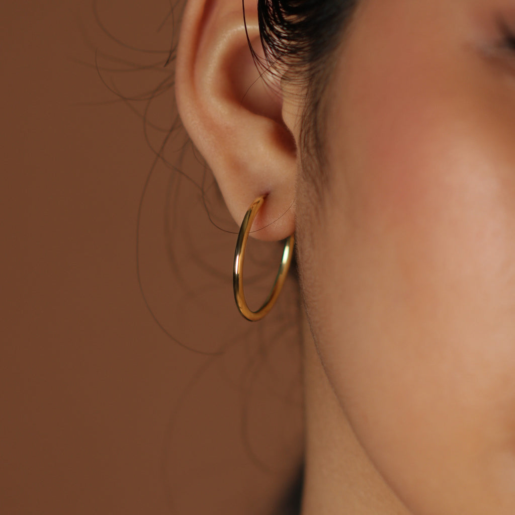 Large Easy Hoops 18k gold stacked on model ear  – Foundry