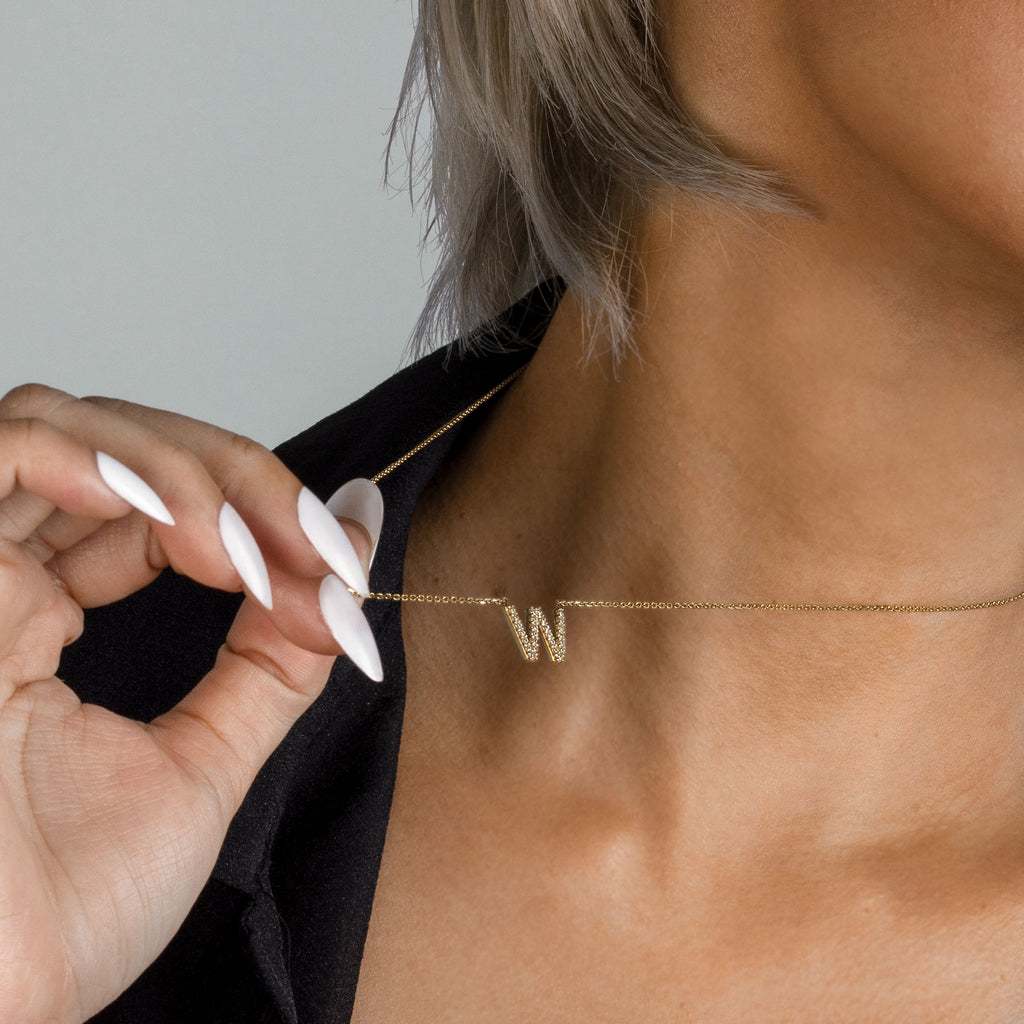 Letter Necklace 14k gold stacked on model neck – Foundry