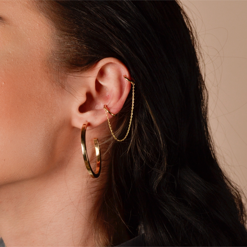Long Chain Huggie Earrings 14k gold stacked on model ear – Foundry