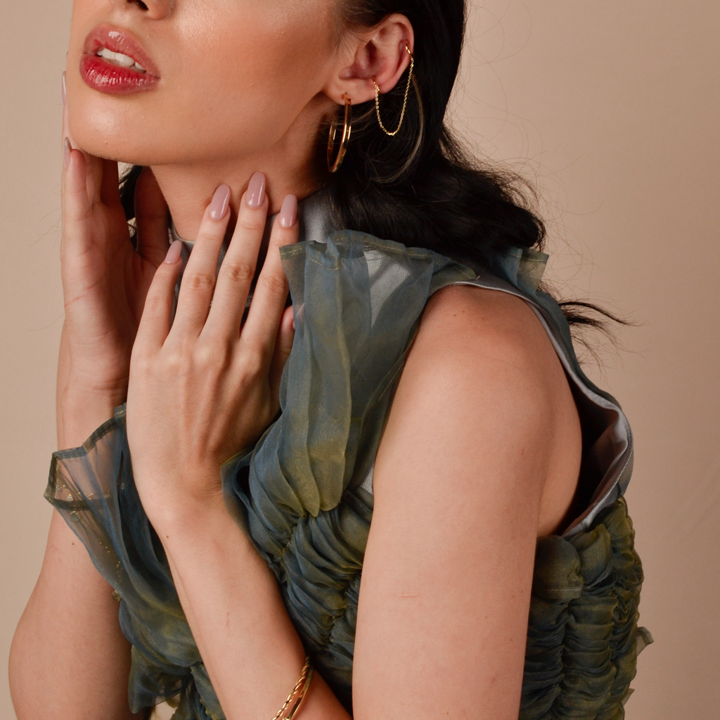 Long Chain Huggie Earrings 14k gold stacked on model ear – Foundry