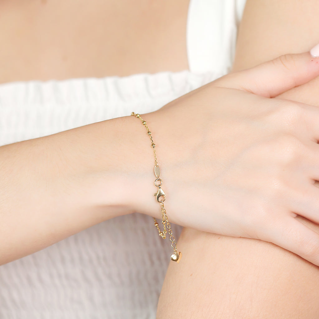 Small Beads Bracelet 14k gold stacked on model wrist – Foundry