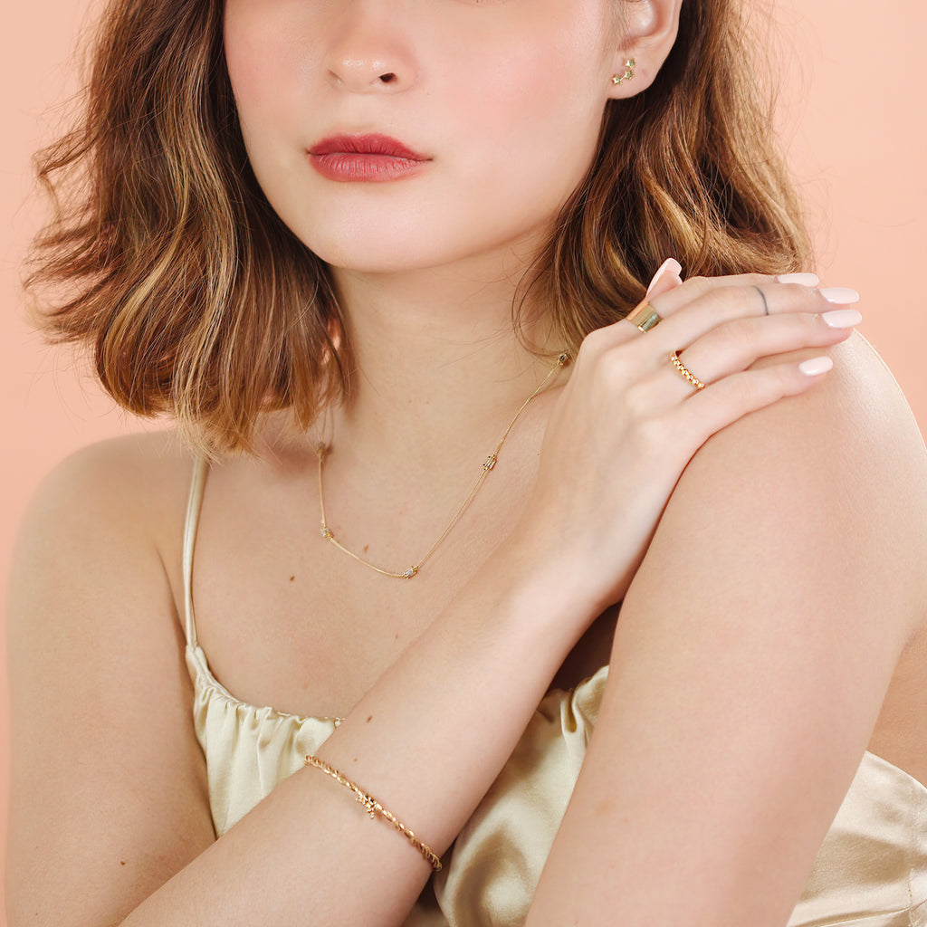 Rope Bangle 14k gold stacked with bangles on model wrist – Foundry