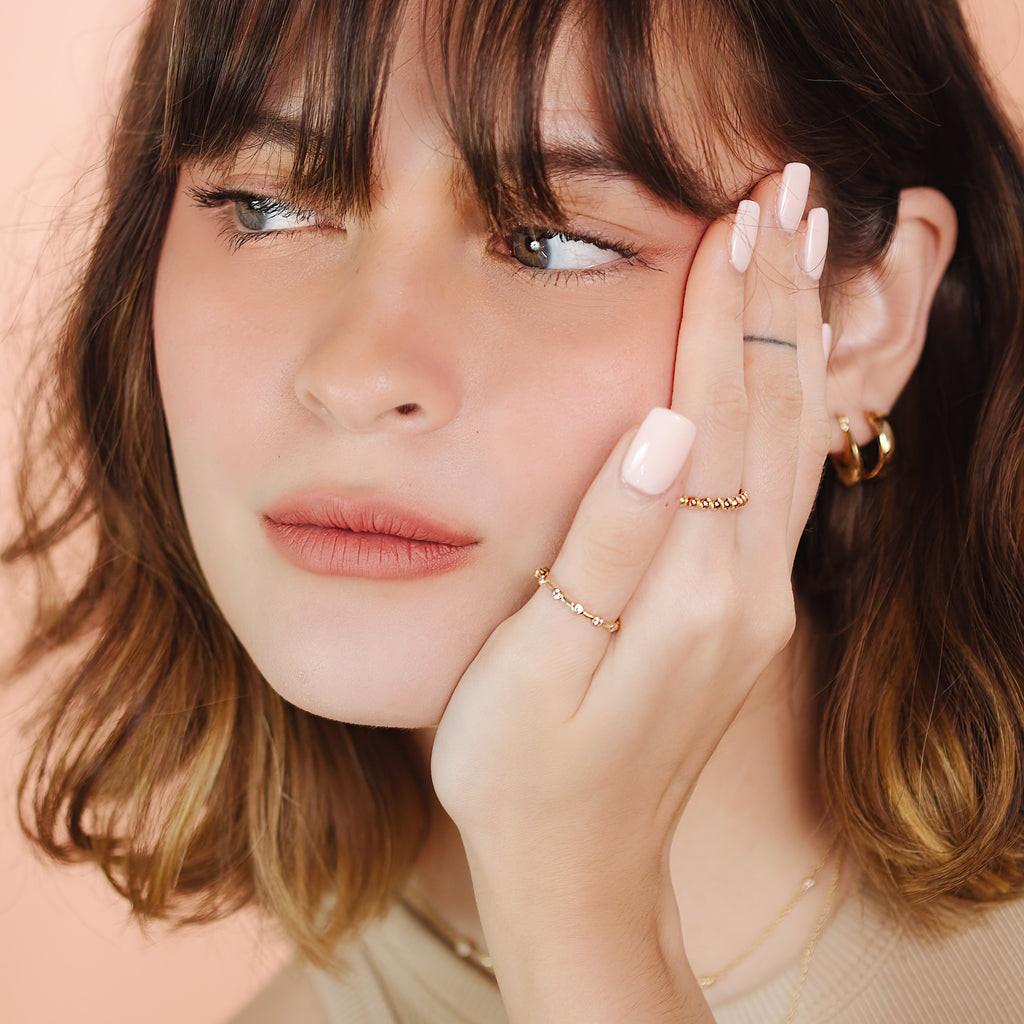Station Eternity Ring 14k gold stacked on model finger– Foundry