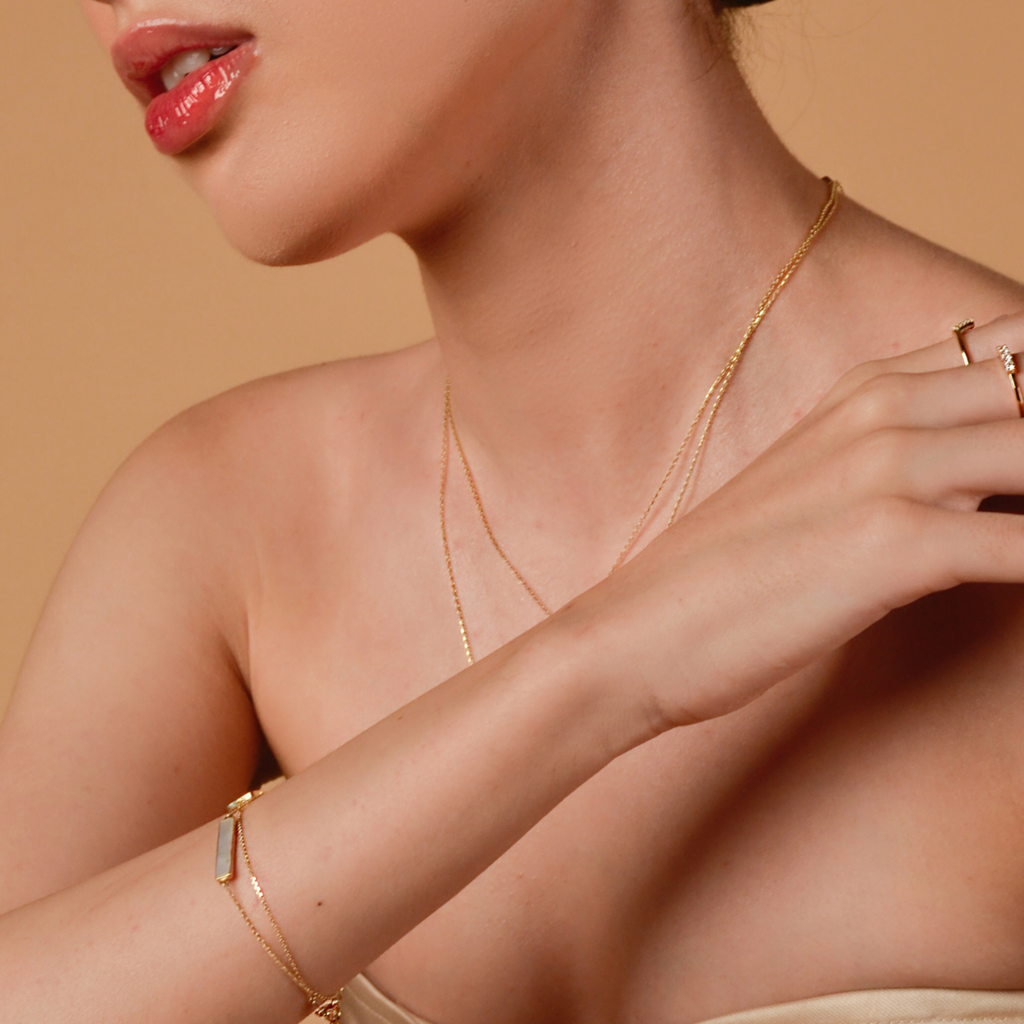 Mother of Pearl Bar Bracelet 14k gold stacked on model wrist – Foundry