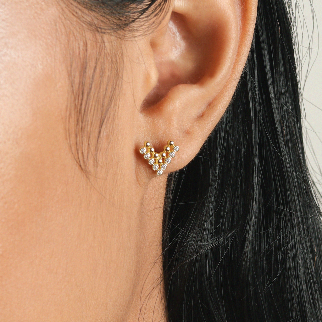 Pave Chevron Studs 14k gold stacked on model ear – Foundry