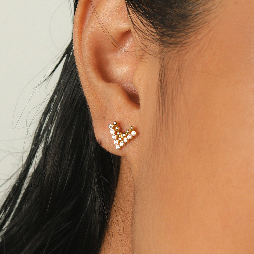 Pave Chevron Studs 14k gold stacked on model ear – Foundry