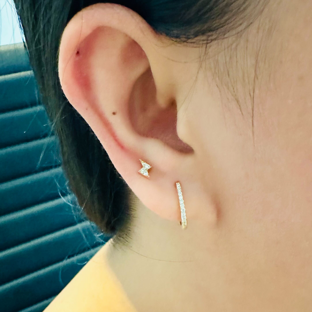 Pave Diamond Huggie Hoops 18k gold stacked on model ear – Foundry