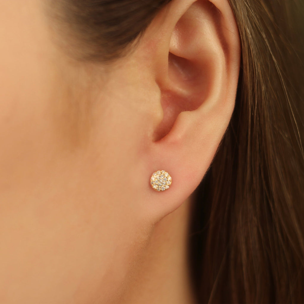 Pavé Diamond Round Studs 14k gold stacked on model ear – Foundry