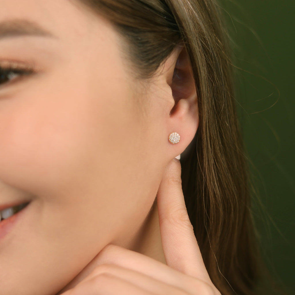 Pavé Diamond Round Studs 14k gold stacked on model ear – Foundry